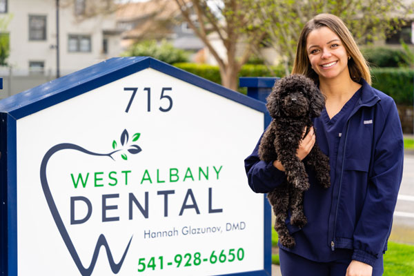 Wiz and Dentist in front of sign